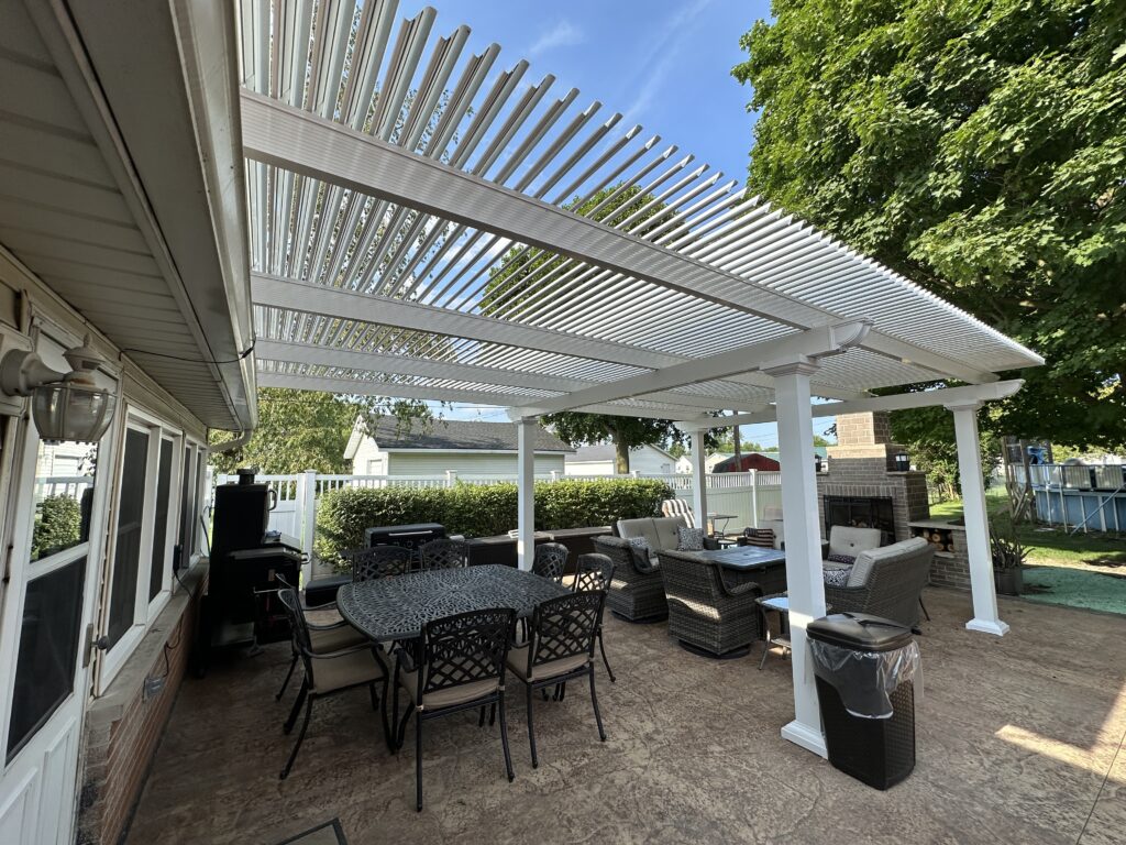 Custom white pergola providing shade over a stylish outdoor seating area with wicker furniture and a dining table, enhancing backyard living space in a Delaware home.